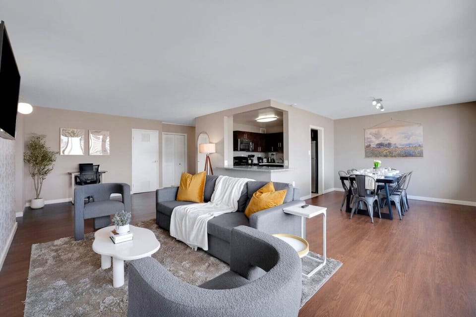 Sink into the sectional, swivel toward the 55-inch smart TV, or drift over to the dining table — this open layout keeps everyone connected.