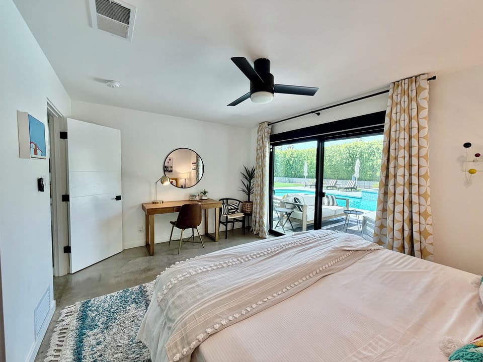 Colorful king room: desk, blackout shade, sound machine, bedside chargers, views