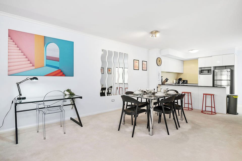 Modern open space with dining and kitchen setup.