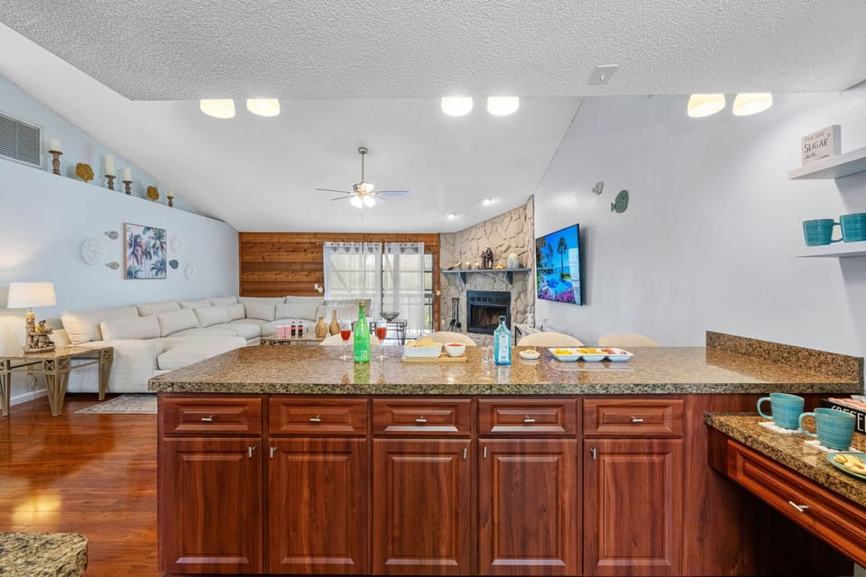 The kitchen is lined with deep cherry wood cabinets that provide a sense of warmth and elegance.