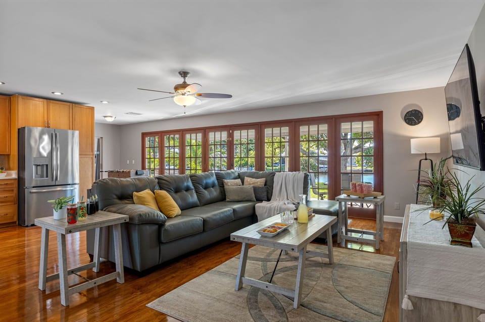 Featuring gleaming hardwood floors, a neutral color palette, and stylish furnishings, this living space balances modern design with homey comfort.