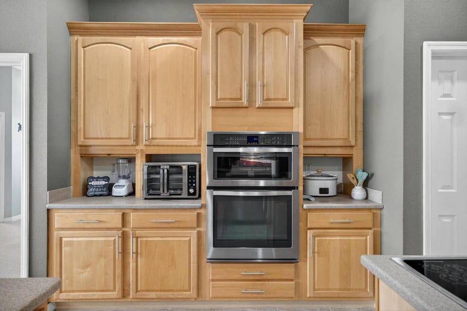 Well-equipped kitchen area with oven, microwave, and appliances, designed for convenience and effortless meal preparation.