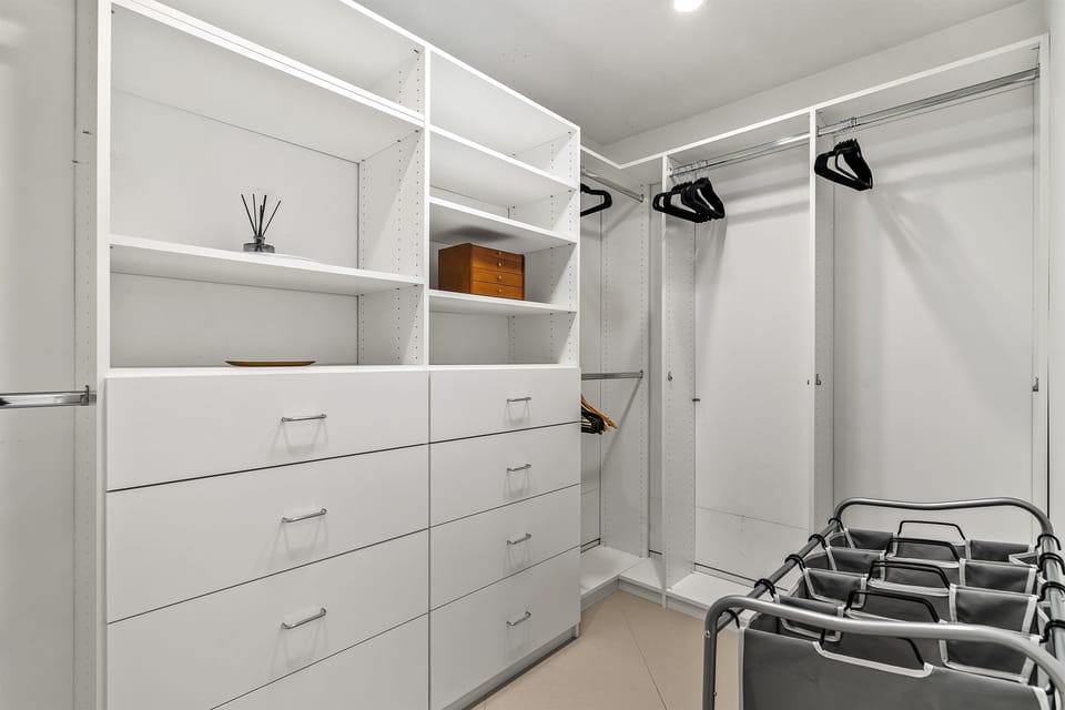 Walk-in closet of primary poolside king bedroom