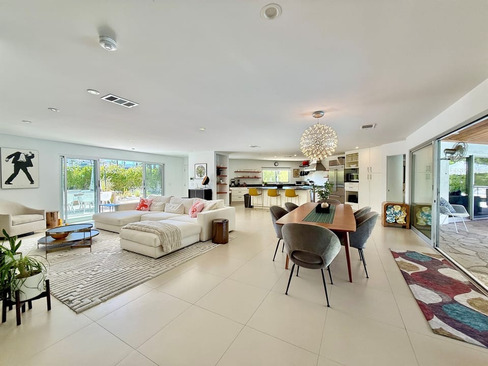 Main living space flanked by sliders on both sides to the outdoor patios