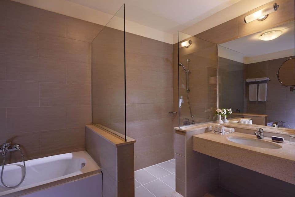 Refresh in a spacious bath with glass shower and tub