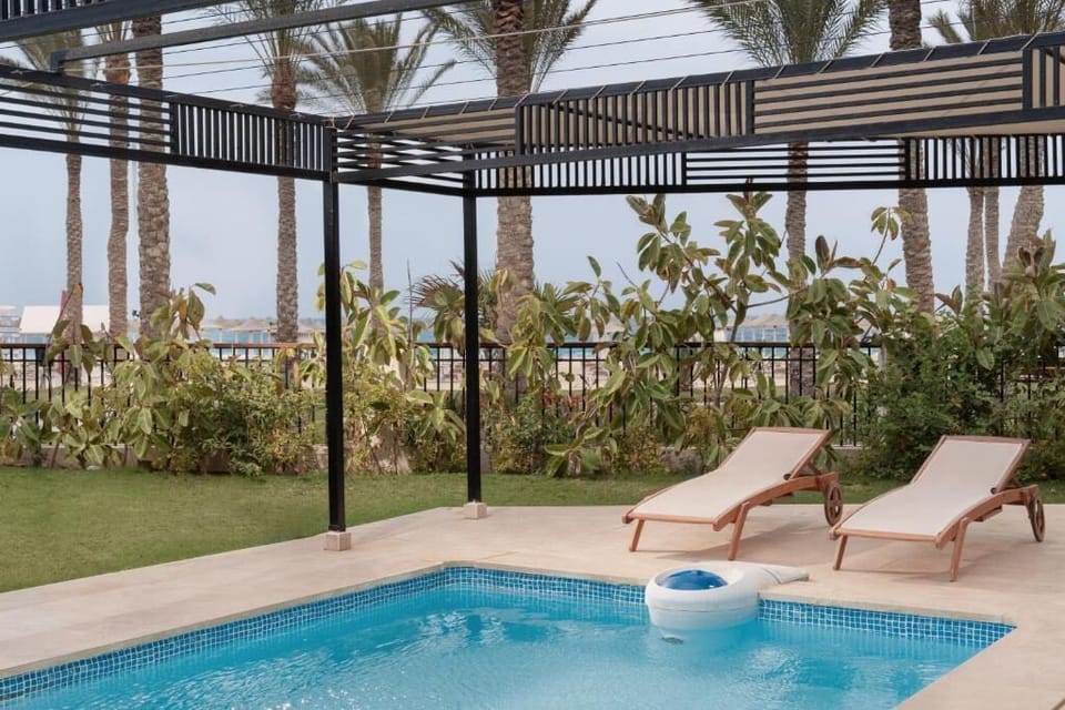 Soak up the sun beside the refreshing pool and loungers.