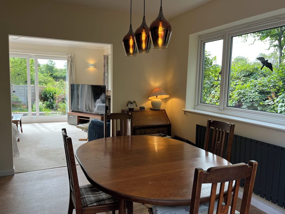 Line-of-sight view from deck through the dining & living spaces to rear patio