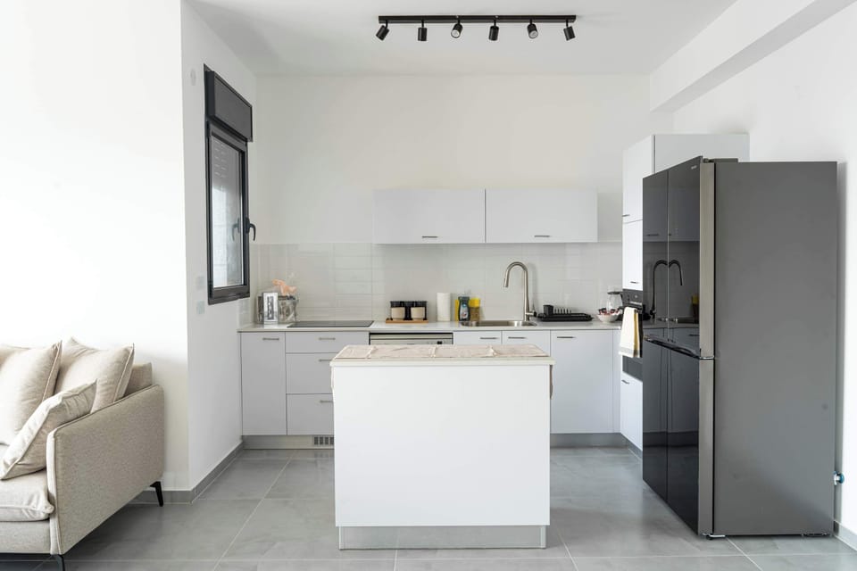 Modern kitchen with island makes home cooking simple, whether preparing breakfast or easy beachside dinners.