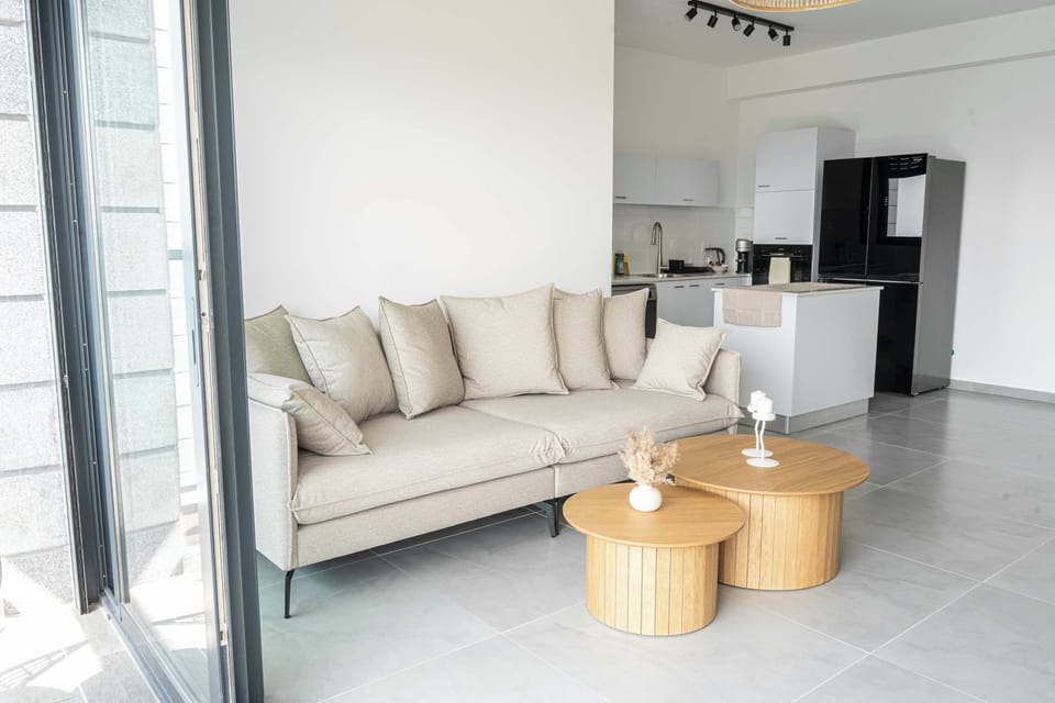 Comfortable sofa beside the kitchen creates an easygoing spot for conversation and quiet downtime.