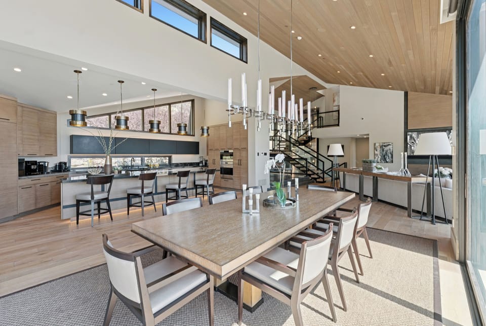 a view of the table and eat-in island in the kitchen