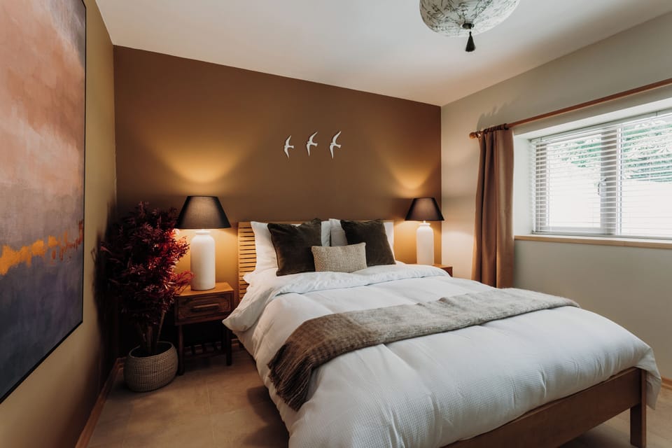 Serene master bedroom with king bed and soft, layered linens.