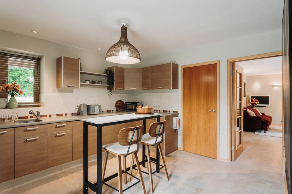 Stylish kitchen with modern appliances, fully equipped for home cooking.