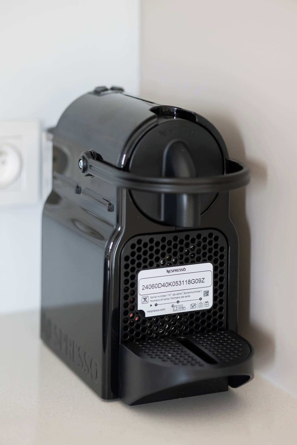 A coffee machine placed on a white kitchen counter, ready for use.