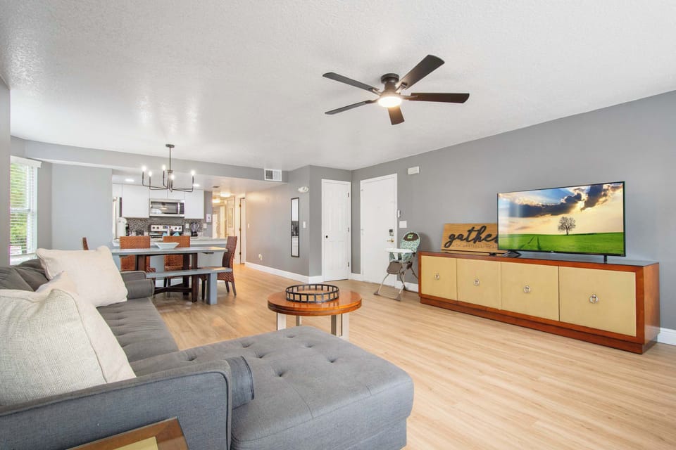 Cozy sectional, huge TV, and open dining space. 
