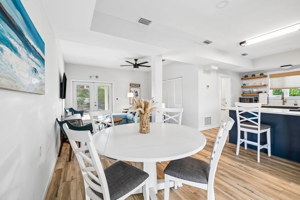 Gather around the welcoming dining table where meals and memories come together in this sun-filled open living space, designed for your comfort and connection.
