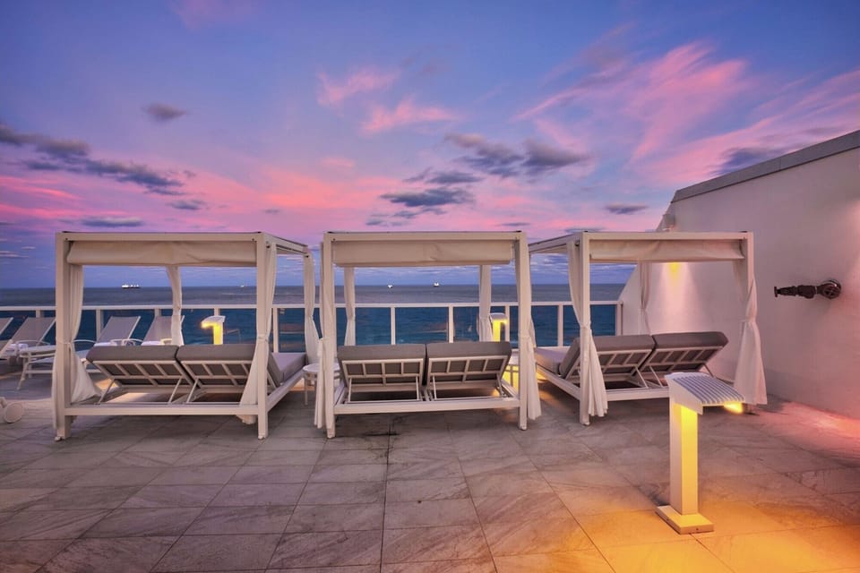 Lounge at sunset in breezy cabanas overlooking the sea.