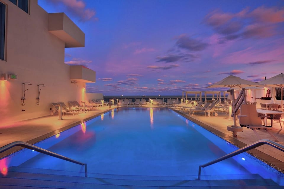 Soak in twilight calm as pool lights shimmer softly.