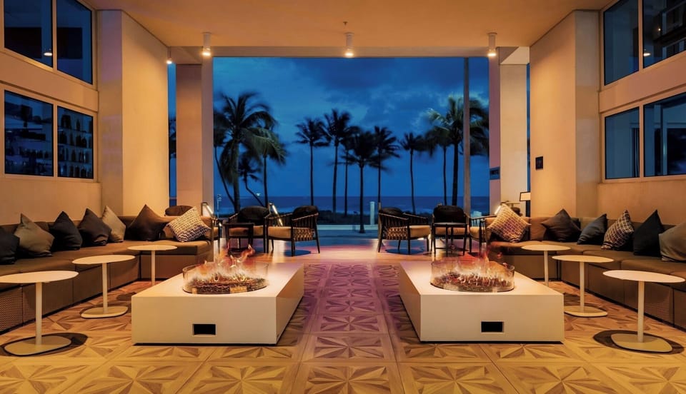 Sink into chic lounge seating with oceanlight beyond the doors.