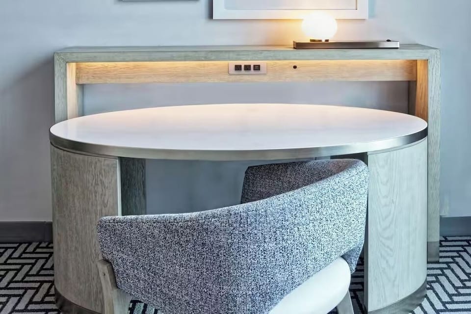 Settle in and focus at a stylish desk with easy outlets.
