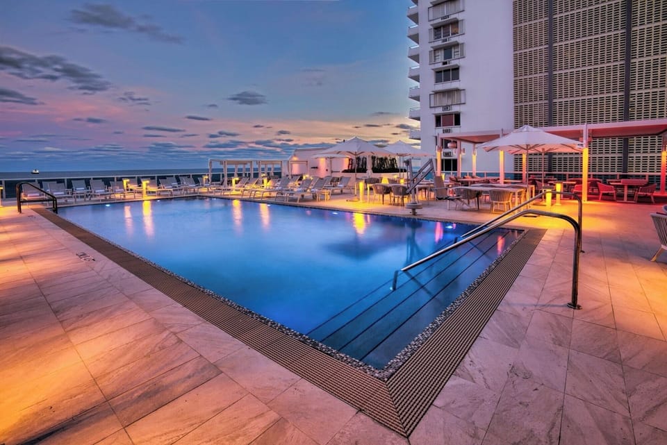 Stretch out on spacious deck seating beside the sunset pool.