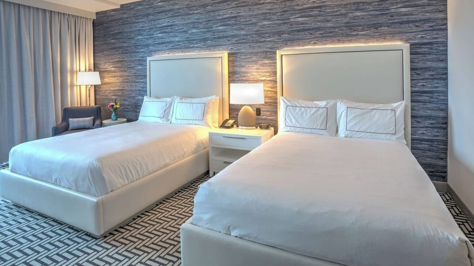 Unwind together in a spacious double-queen room, perfectly styled.