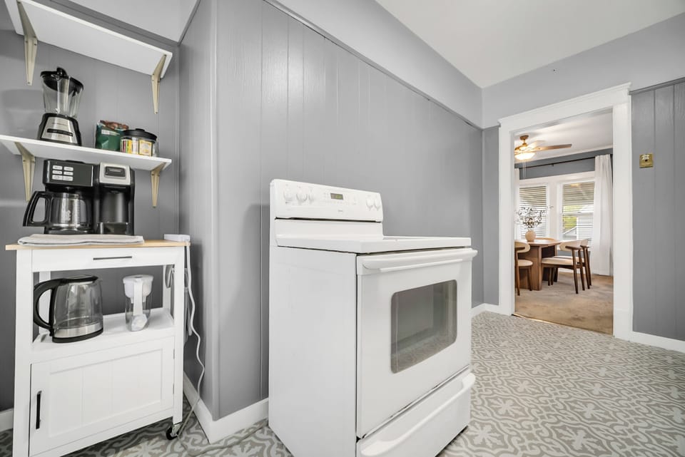 Kitchen includes a full-size oven, fridge, electric kettle, and coffee maker