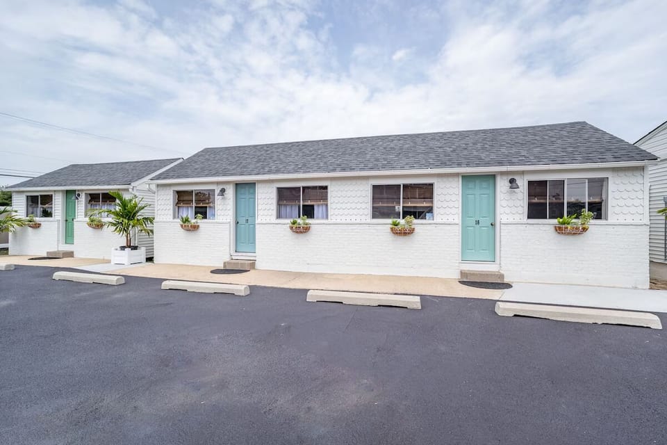 Settle into a charming row of rooms with fresh coastal curb appeal.