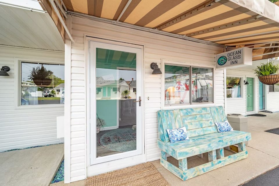 Arrive and unwind on the covered porch with seaside vibes.