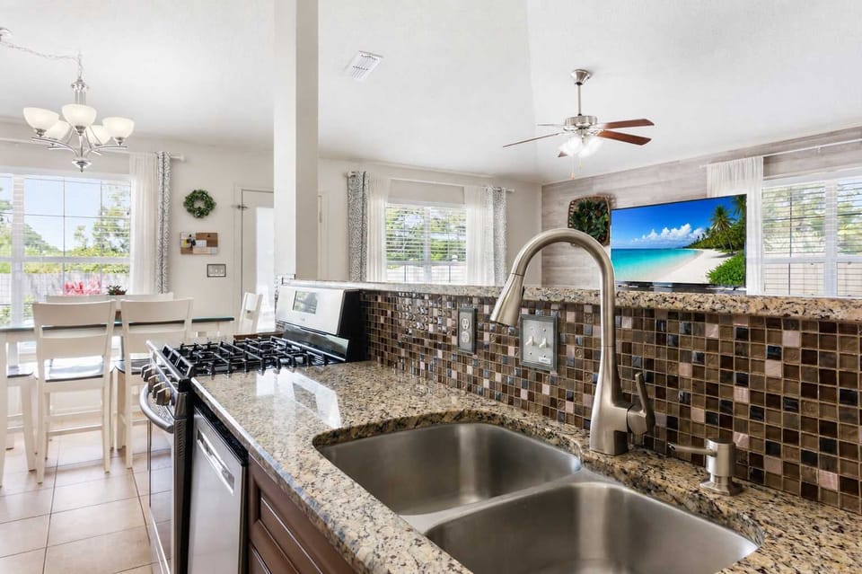 Fully equipped kitchen with stainless appliances and lots of prep space for meals, snacks, and game nights