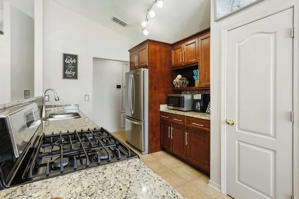 Fully equipped kitchen with gas range  stove, granite counters, stainless appliances and lots of prep space for meals, snacks, and game nights