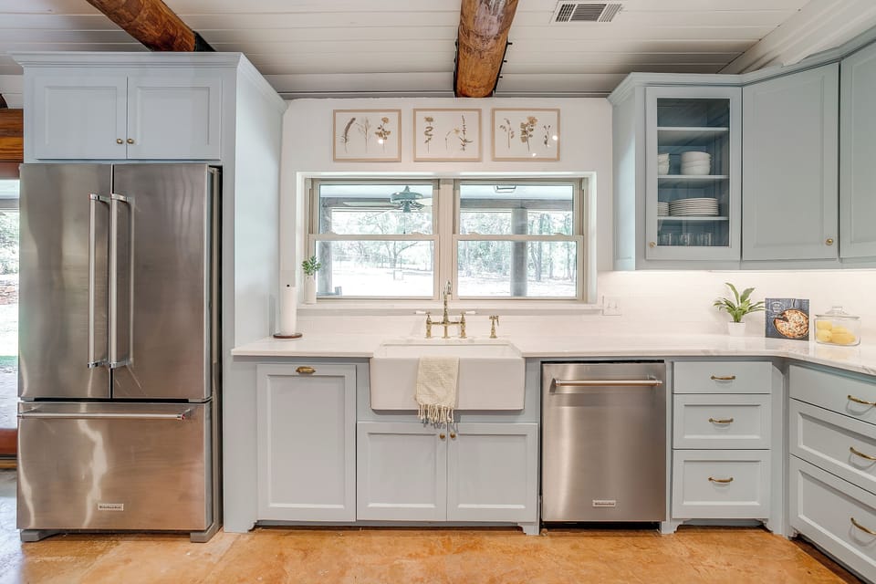Large windows flood the space with natural light while open shelves add style.