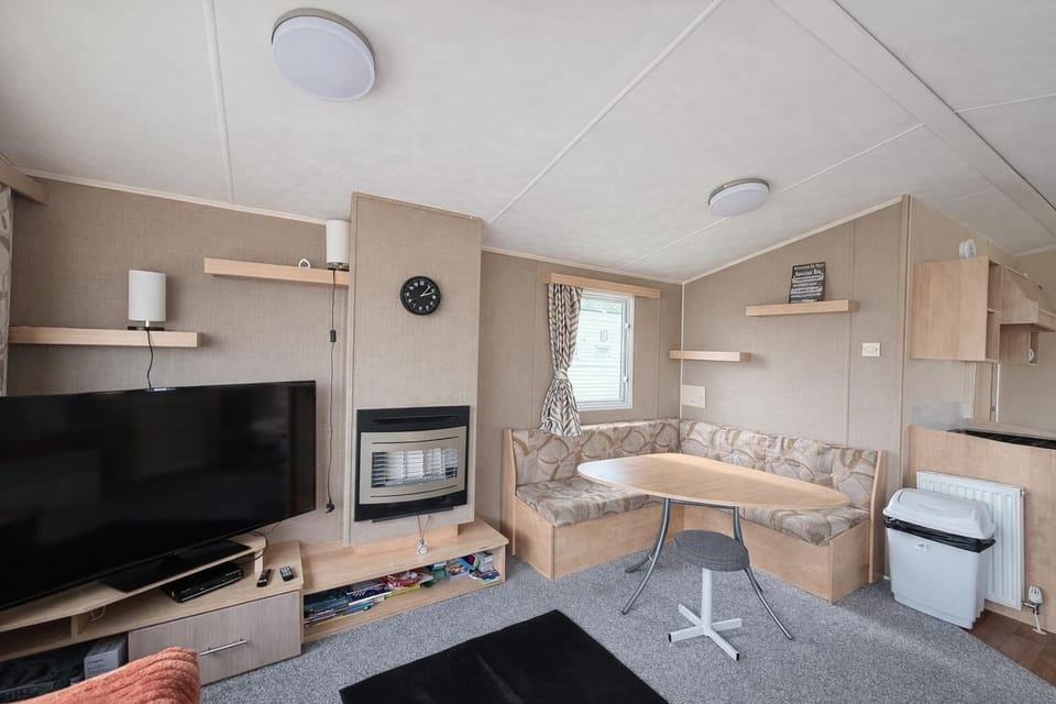 Relax in the comfortable living room of your holiday home, making it the perfect coastal escape for pet owners seeking comfort and convenience.