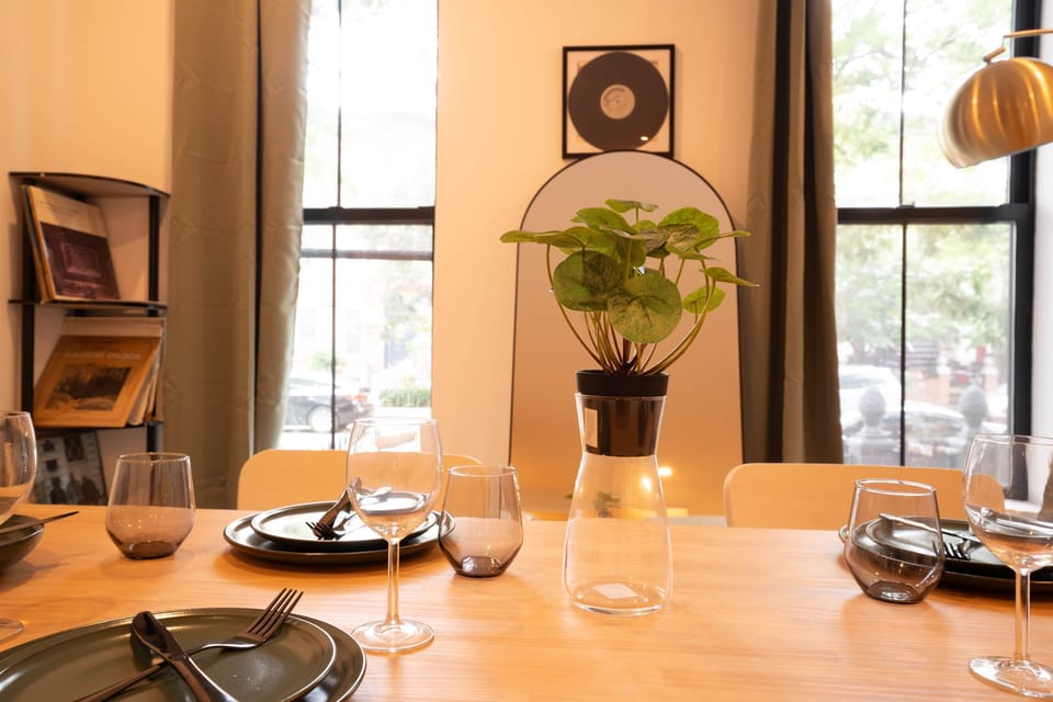 Sophisticated dining table set with elegant tableware, floral centerpiece and warm lighting