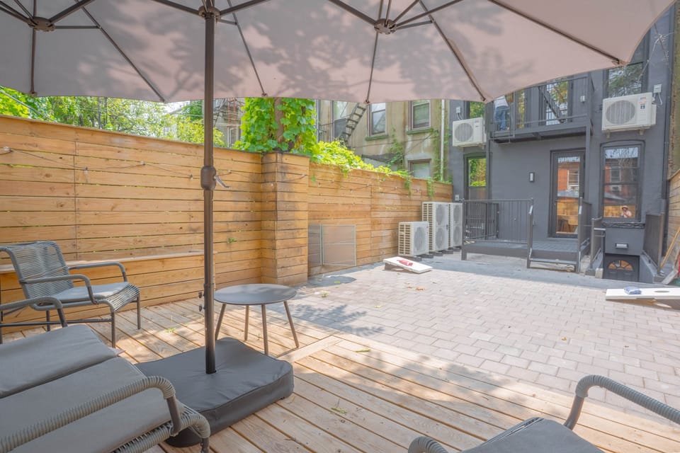 Shaded backyard area with comfortable seating, patio games and secure fencing for privacy
