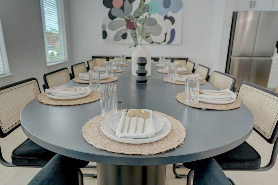 Stylish dinner table with sleek black chairs and a centerpiece for gatherings.