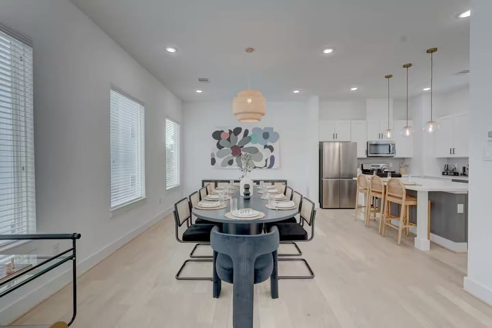 Elegant dining room flows into a sleek kitchen, perfect for entertaining guests.
