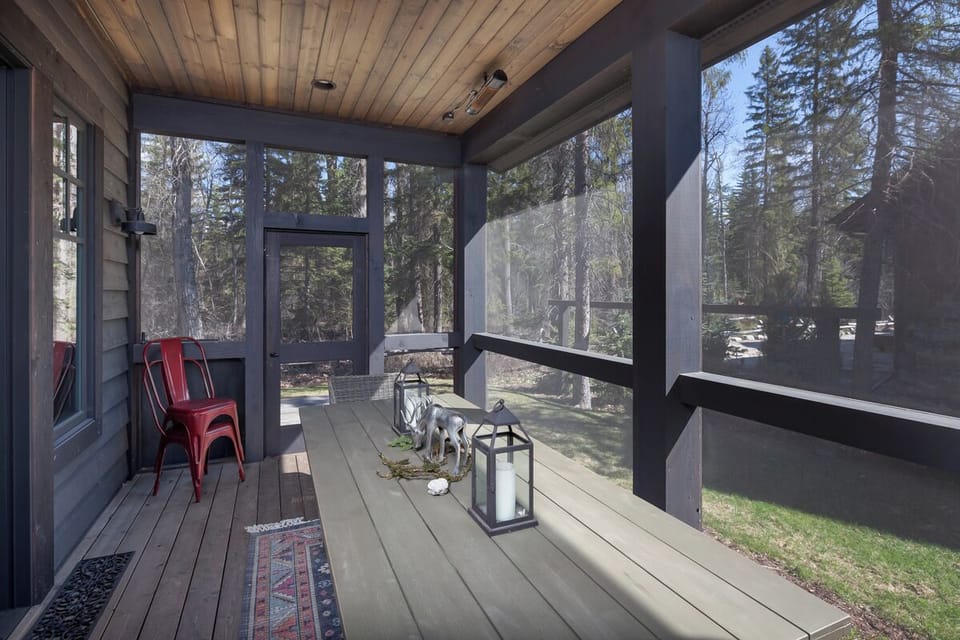 Sip morning coffee on the screened porch, surrounded by pines.