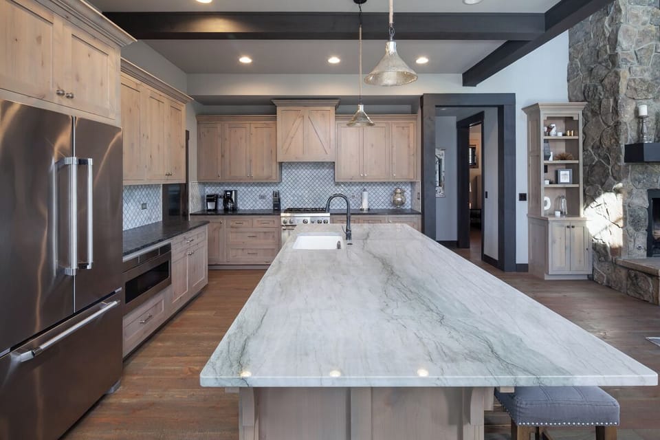 Cook together around the expansive marble island and chef range.