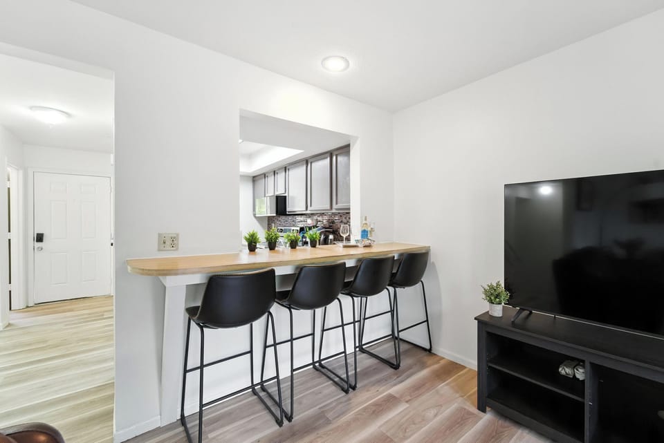 Dining counter with four comfortable bar chairs, with serving access from the kitchen