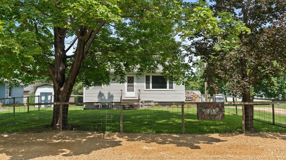 The large fenced front yard is shaded by two large maple trees. Parking is directly out front. 