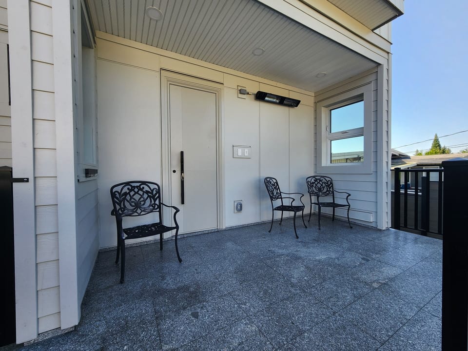 Outdoor patio with infrared heater and view of garden.