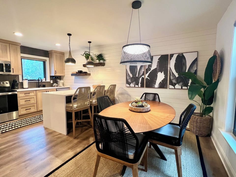Whip up delicious meals in this modern kitchen featuring stainless steel appliances, a deep farmhouse sink, and stylish light wood cabinetry.