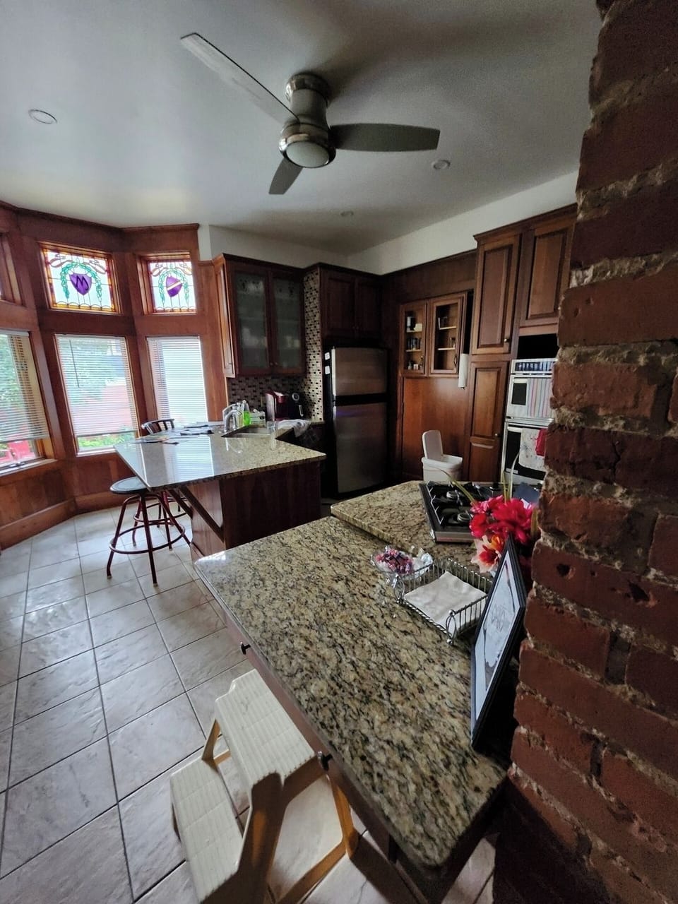 Here we have a modern, well equipped eat in kitchen with a stained glass bay window. 