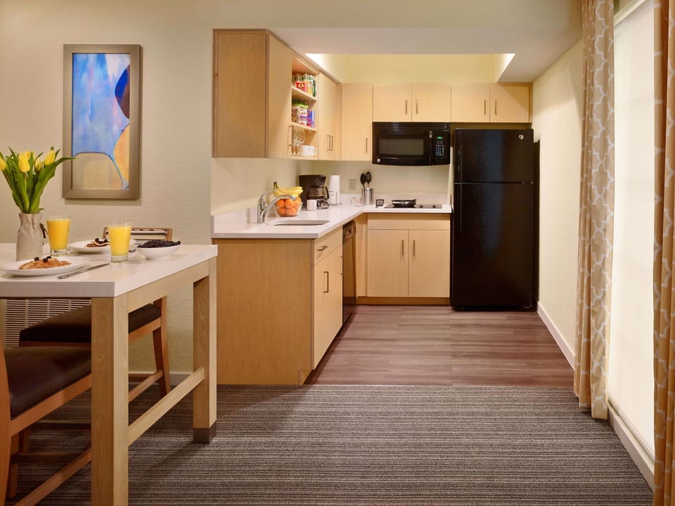 Cook easy meals in the bright kitchen with full fridge.