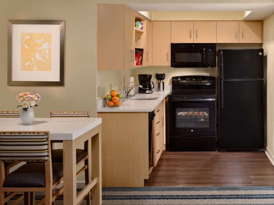 Cook with ease in a sleek kitchenette with full appliances.