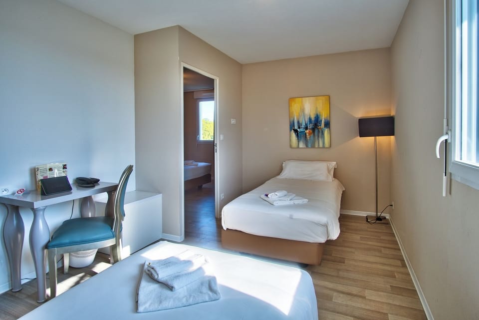 Rest easy with twin beds and a calm, airy layout.