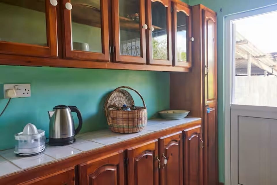 Convenient kitchen counter with a kettle and useful storage space.