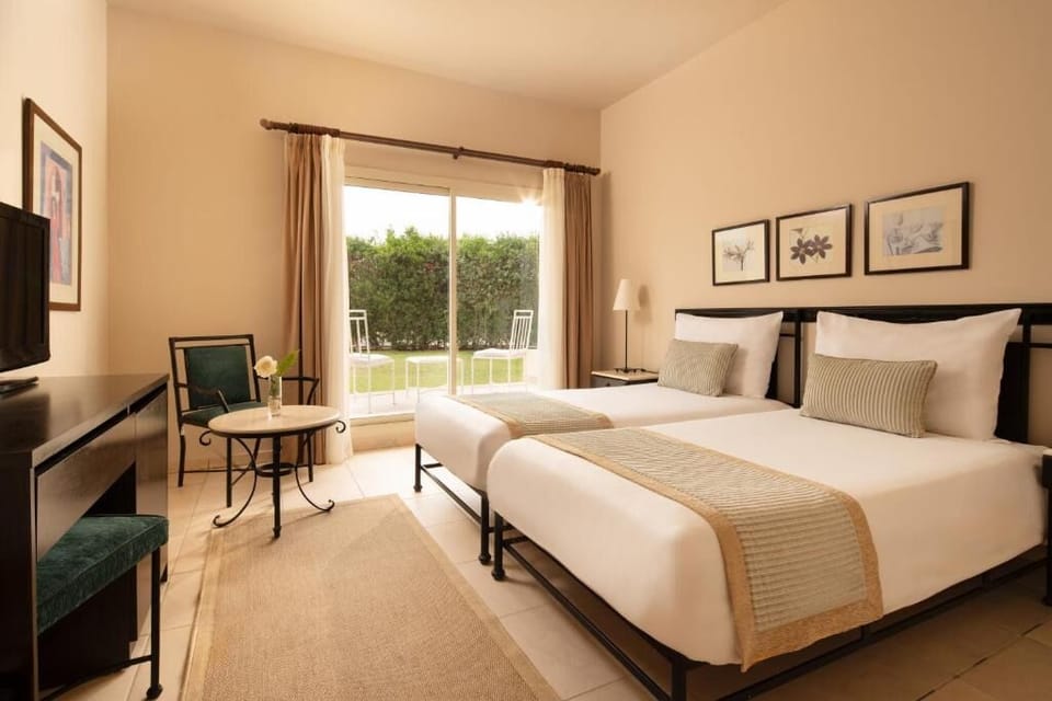 Unwind in airy twin beds with garden-view sliding doors