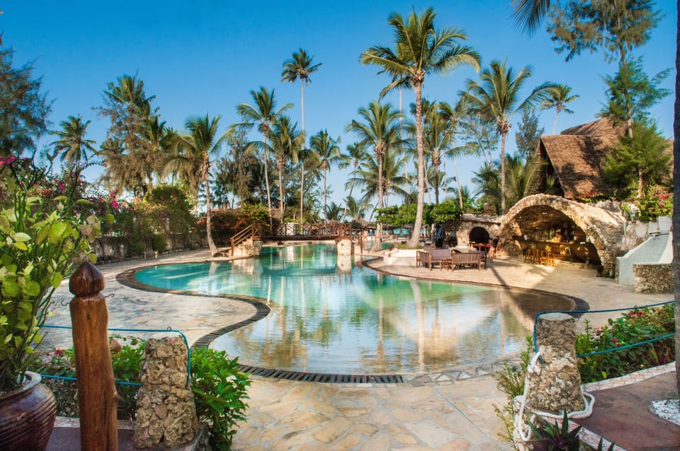 Unwind poolside on warm stone decks in tropical serenity.