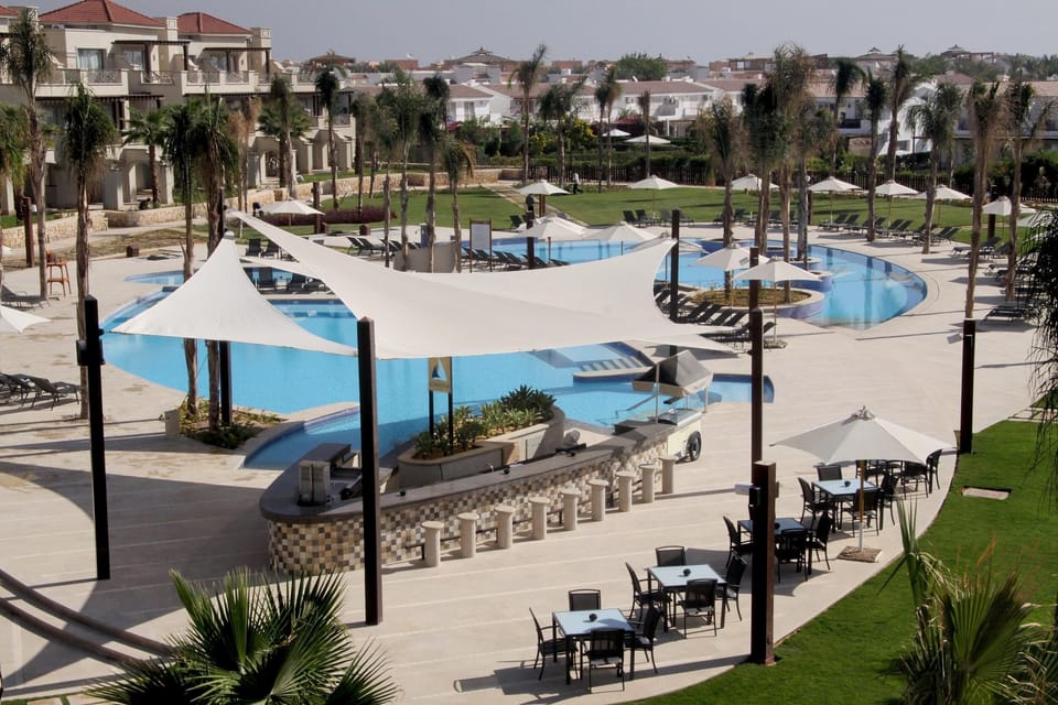 Dive into resort pools framed by palms and open skies.
